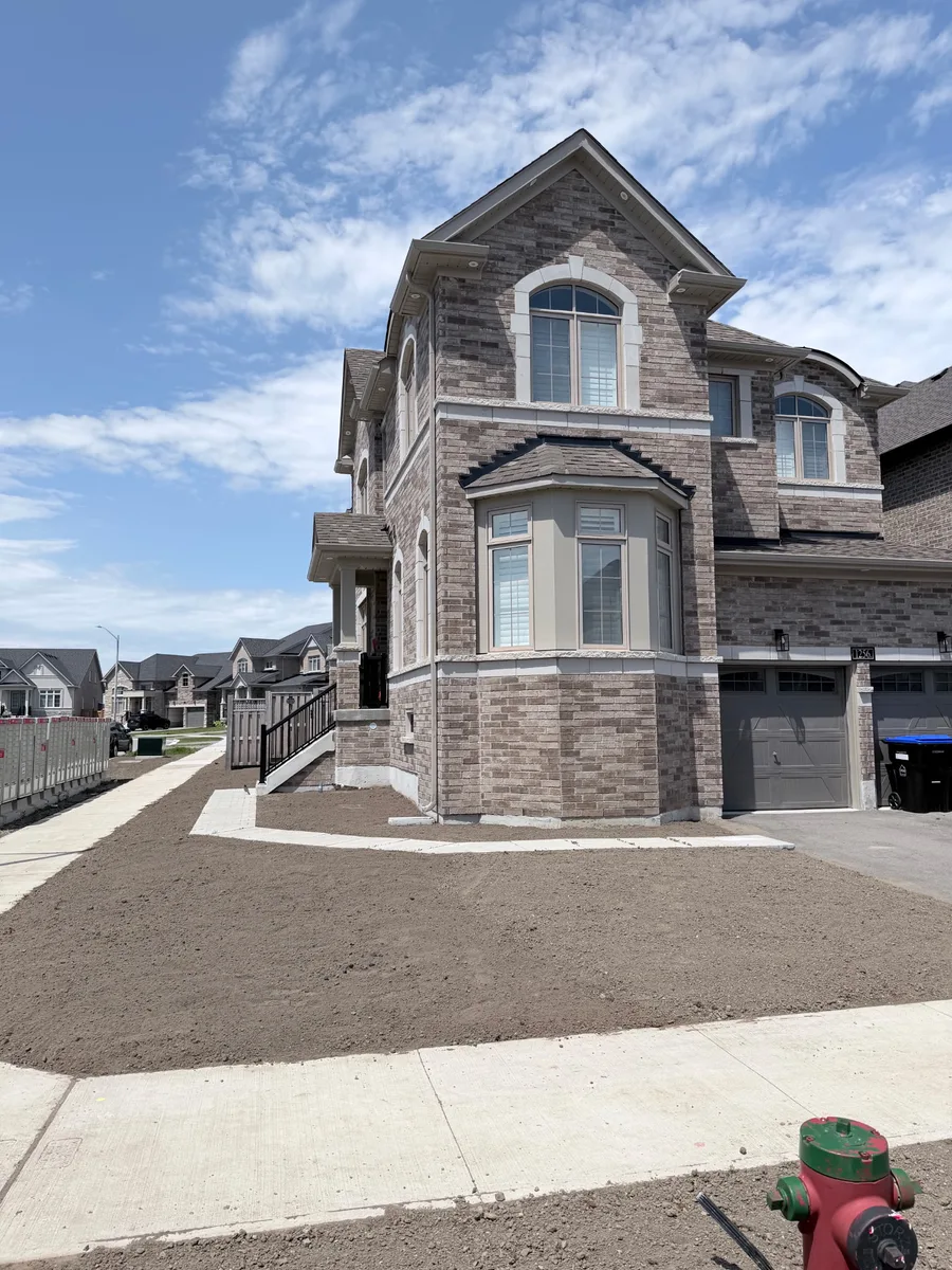 Graded topsoil prepared for fresh sod at a new build home